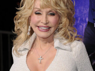 Singer Dolly Parton says reports of her insuring her breasts is 'not true'